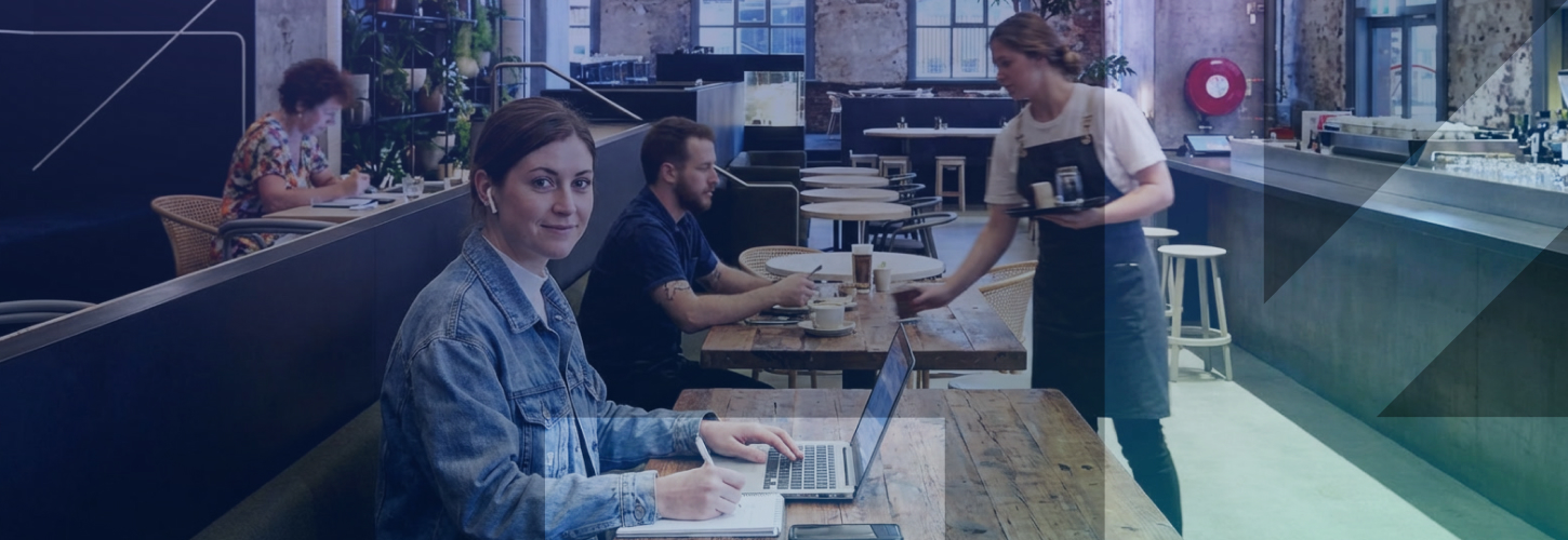 Woman studying and working on laptop at the Higher Ground Cafe in the Melbourne CBD