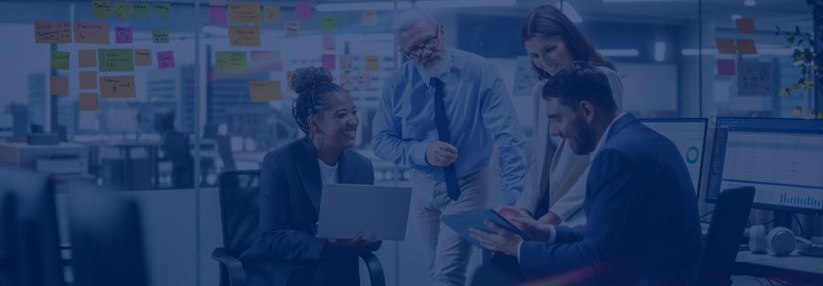 Our ICT training brands at Lumify Group - team of four meeting and reviewing tablet