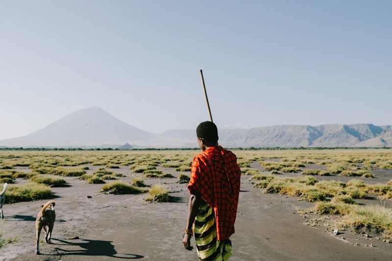 A Maasai man with his two dogs in the vicinity of Mt Ol Doinyo Lengai