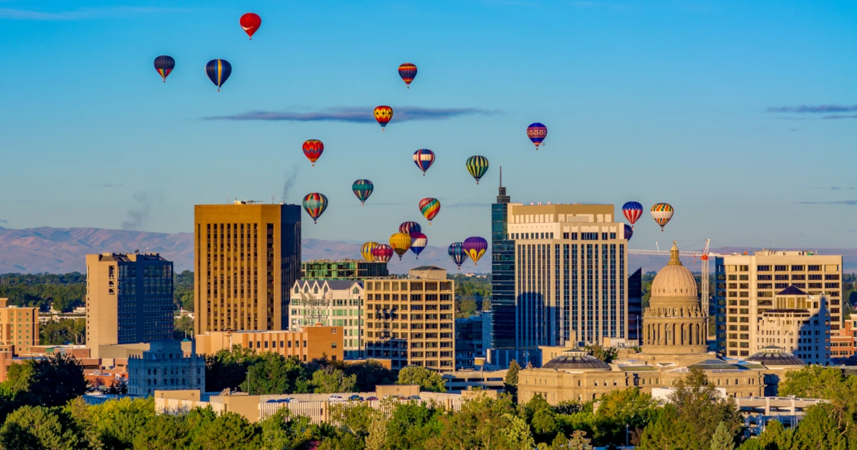 Hot air balloons floating above an Idaho city skyline | Swyft Filings