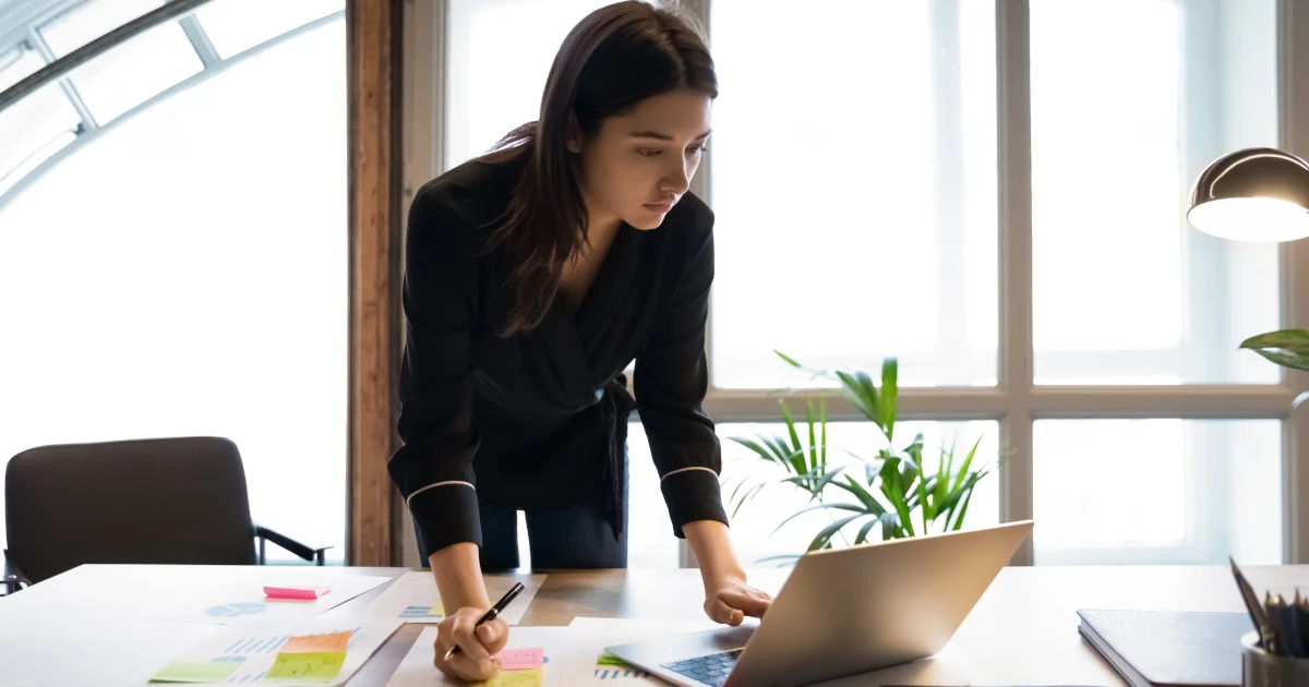 Confident millennial indian female business analyst financial advisor preparing statistic report