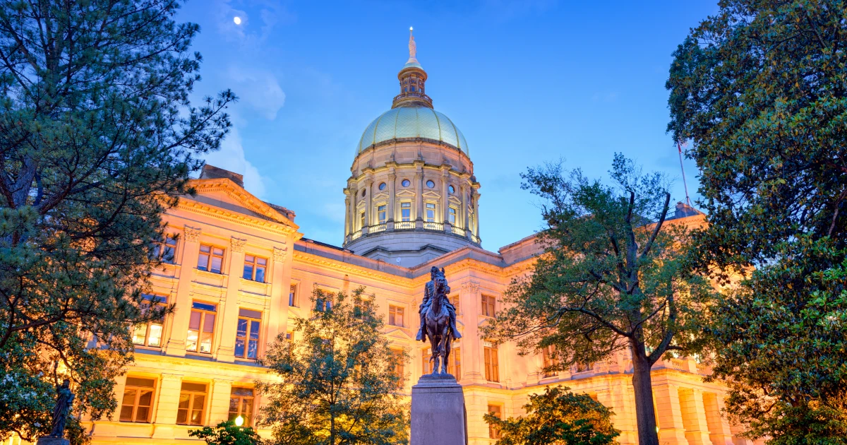 State capital building in Georgia lit up at night with statue in front | Swyft Filings