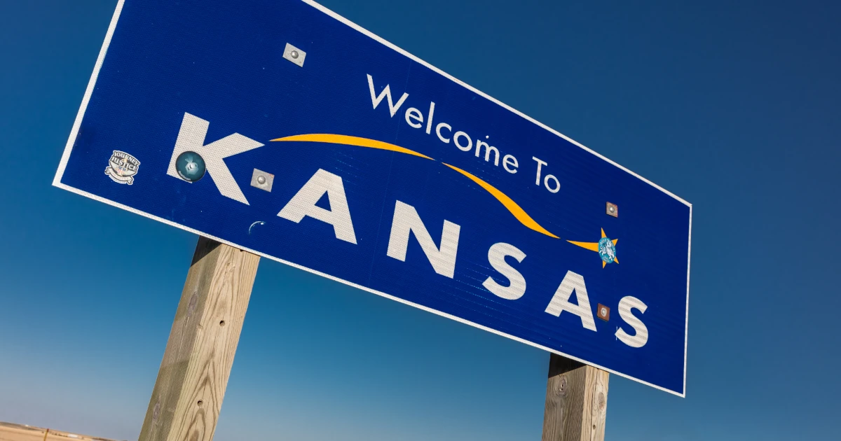Sign on side of the road welcoming drivers to Kansas | Swyft Filings