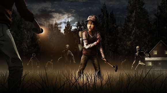 Clementine standing in open field with a flashlight shining on her face. A heard of walkers are walking towards her in the background.