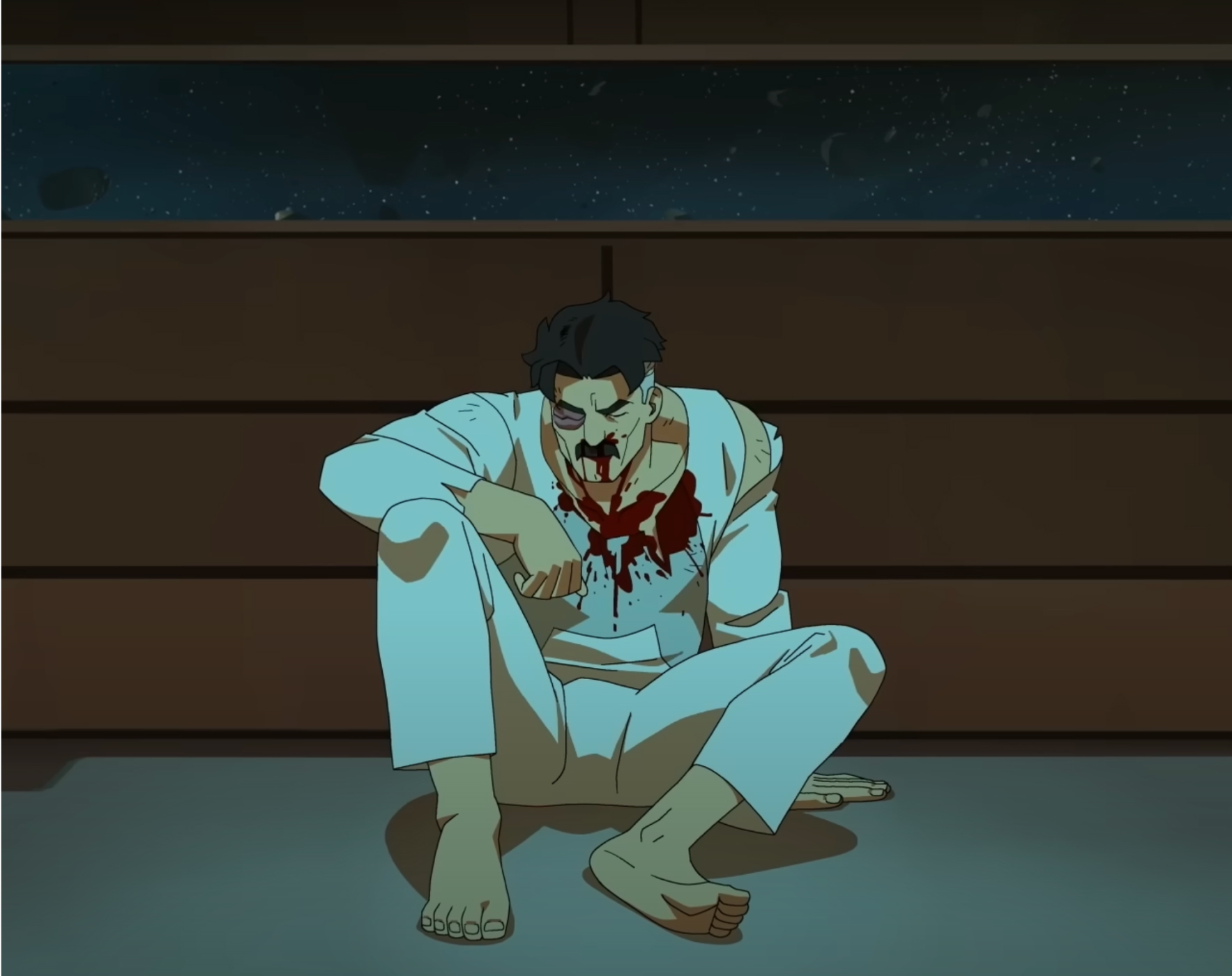 Nolan Grayson covered in blood and sitting on the ground