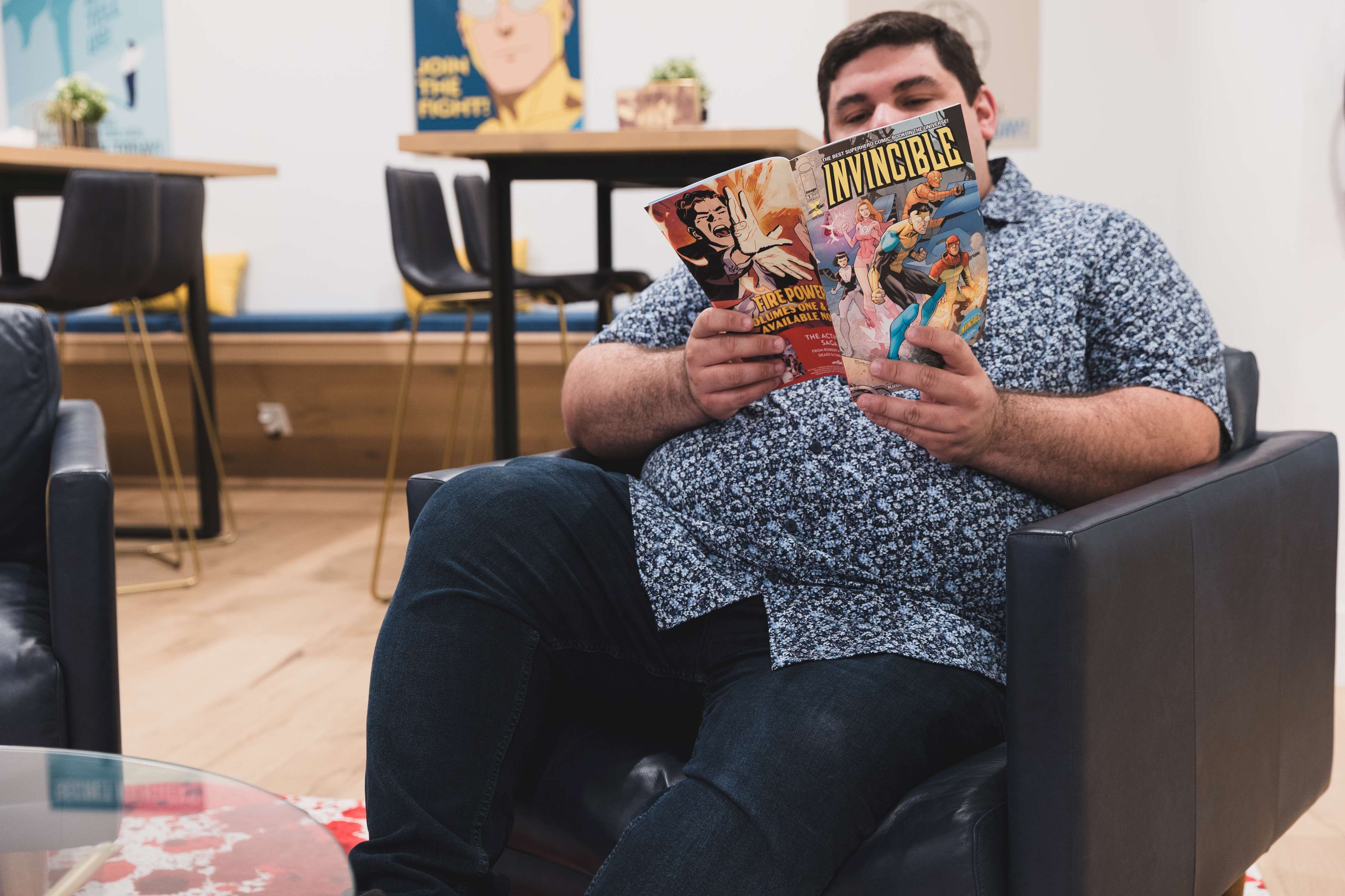 Employee reading an Invincible comic