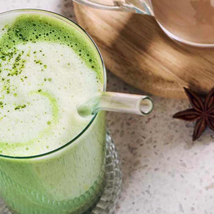 Verre transparent avec du matcha latte et une paille