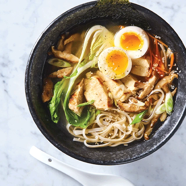 Bol de ramen aux tagliatelles de riz avec poulet, œuf mollet, pak-choï, champignons et algue nori