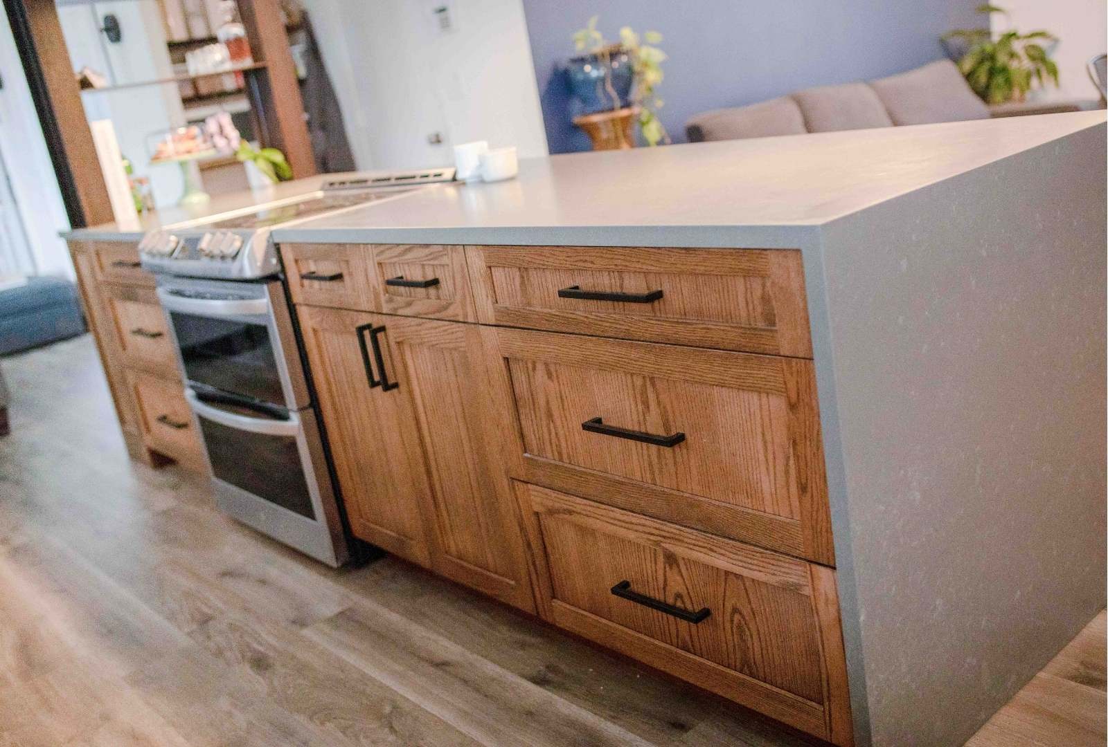 kitchen island with a countertop and warm wood cabinets