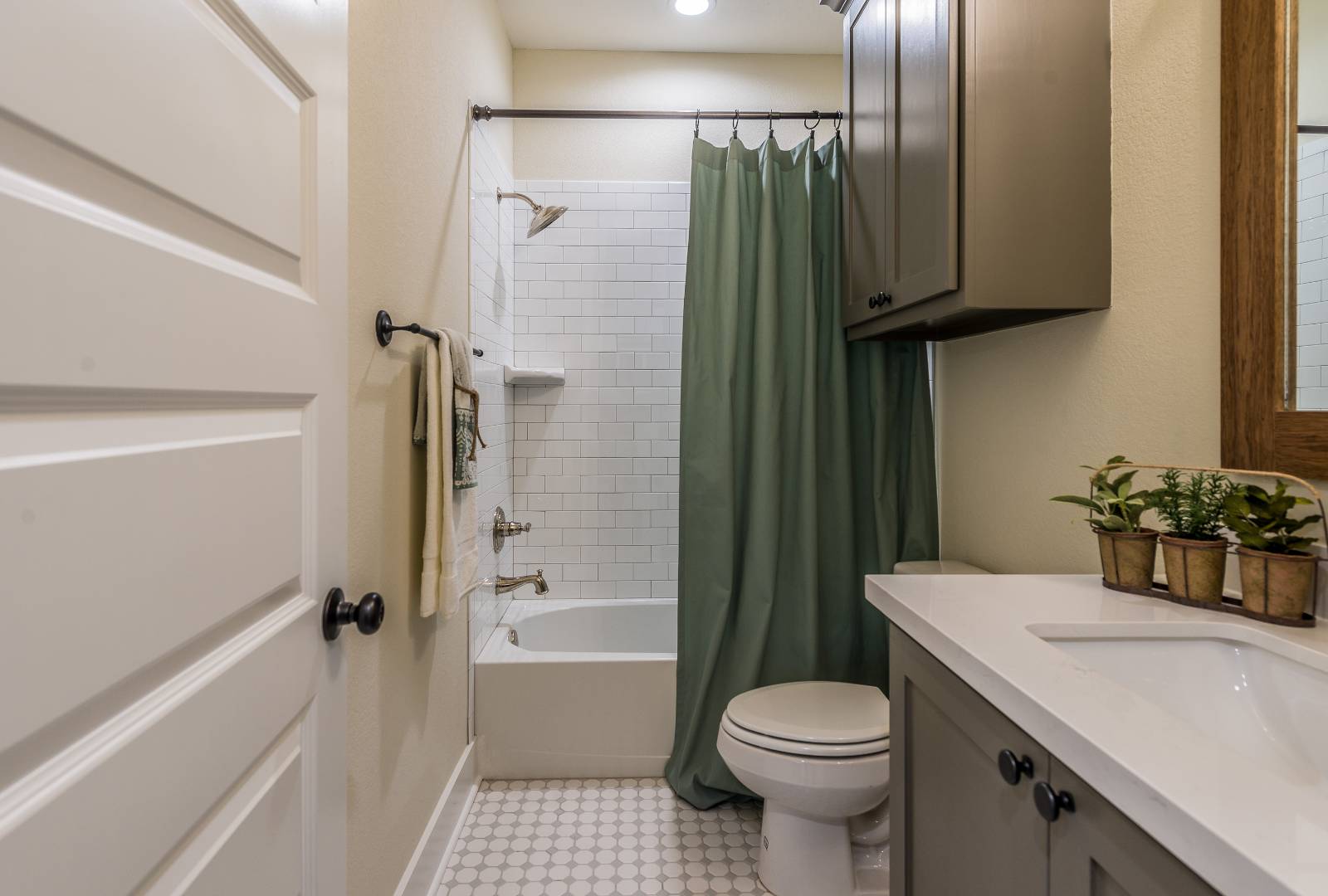 Green shower curtain in newly built bathroom