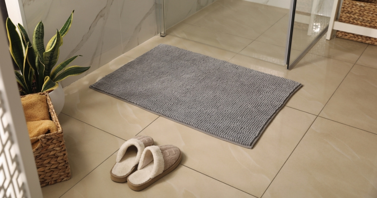 Soft Grey Bath Mat and Slippers on Floor in Bathroom
