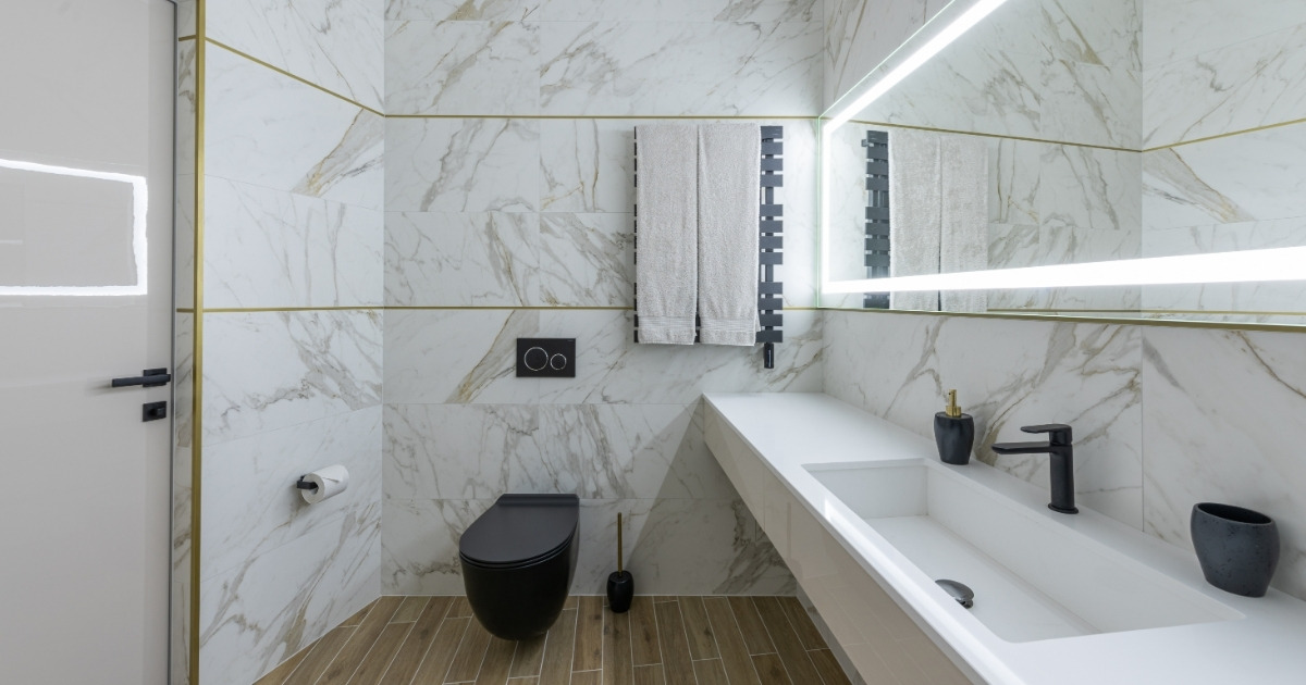 Interior of modern light bathroom with parquet floor and marble walls