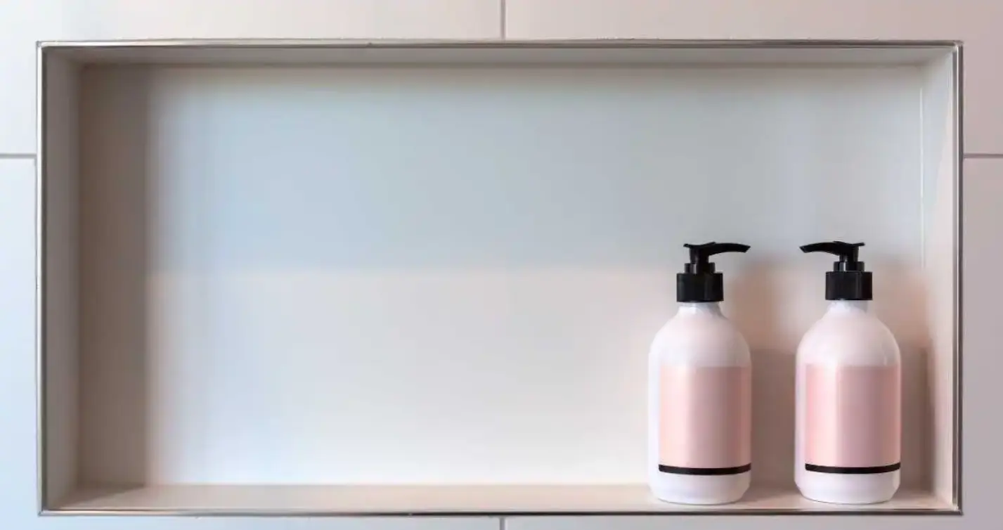 two shampoo dispensers facing each other in white tiles shower niche
