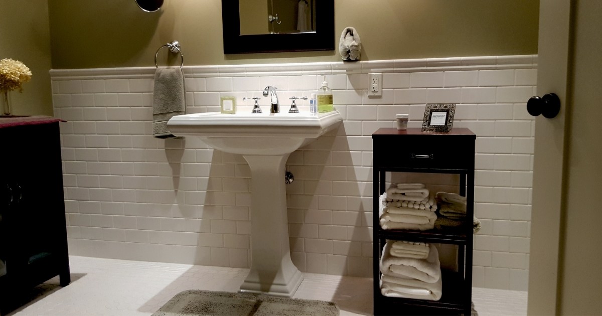 Subway Tiles And Pedestal Sink In New Modern Bathroom