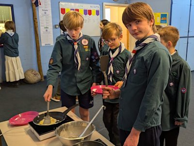 These Scouts are cooking up pancakes in advance of Shrove Tuesday. They look tasty!