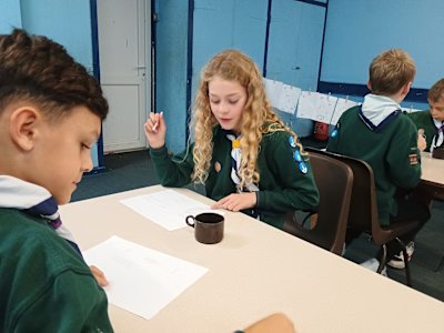 Having squeezed their lemons, these Cubs are busy writing messages in lemon juice. 