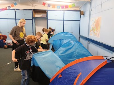 The Cubs are taking down the row of tents used for their sleepover.