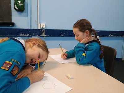 These two Beaver girls are working hard on their coin designs