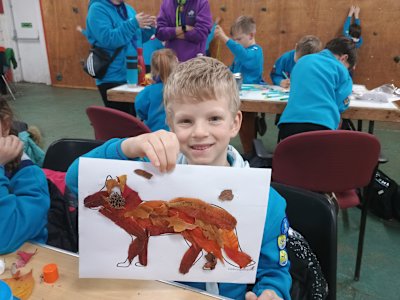 With a huge grin on his face, a Beaver shows off his fox leaf art.