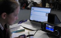 A Scout is learning how to contact other Scouts using amateur radio. She's managed to reach a Scout in Sweden!