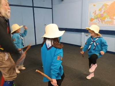 These three Beavers are being taught a Morris dance by an enthusiastic Morris man.