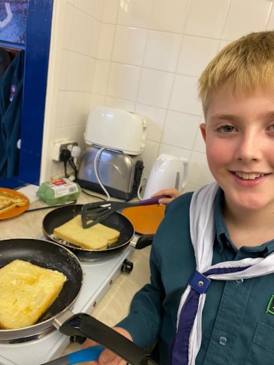 This Scout has a big smile on his face as his French toast is cooking.