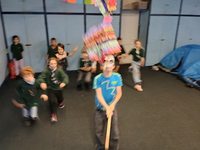 The Cubs race to grab the sweets spilling from the burst piñata.