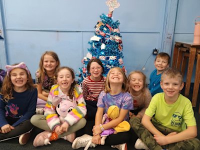 It's been a lovely Christmas sleepover and the Beavers are all posing in front of the Christmas tree they decorated. They are a cheeky lot.