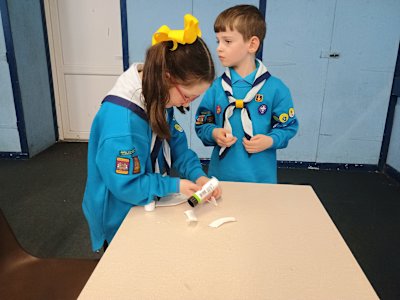 "Oops! We cut off our masks' ears! Can we please glue them back on?" Two Beavers attempt to fix their masks.