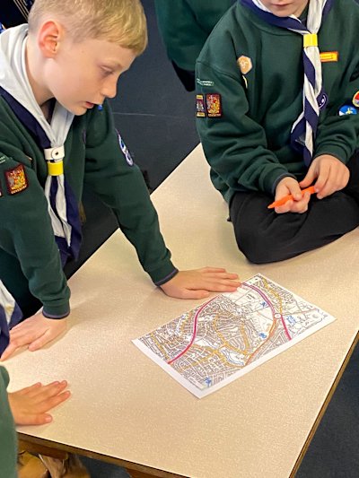 The Cubs are working together to find where services are located on a local map.