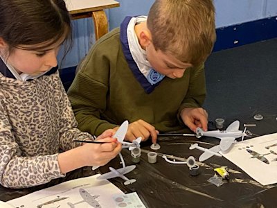 These Cubs are carefully painting their Spitfire Airfix models.