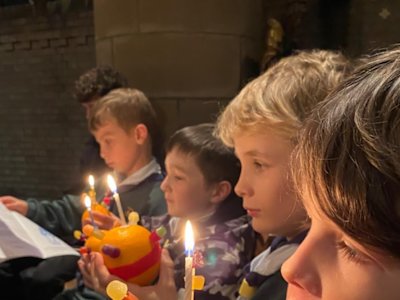 These Cubs are being very careful with their lit Christingles.