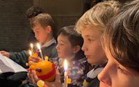 These Cubs are being very careful with their lit Christingles.
