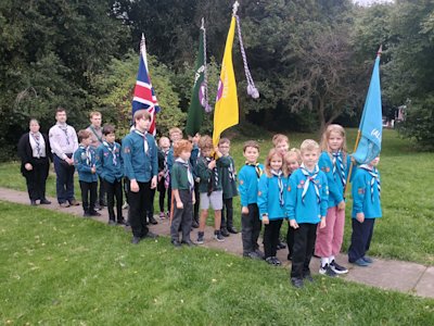 Having managed to exit the hut without catching the flagpoles on the doorways or tree branches, the group stands in formation, Beavers at the front, Cubs in the middle and Scouts bringing up the rear, ready to depart.