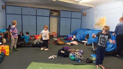 The Beavers are taking their kit out of their tents and packing up. It's incredible how much they can spread it over the floor!