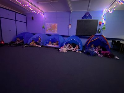 The Beavers are all snuggled up in their beds, watch their Christmas film with the glow of the Christmas lights above them.