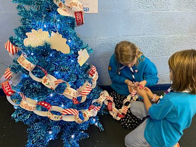 These two Beavers took on the task of making sure the paper chain is wrapped nicely all around the Christmas tree, and are adding on extra rings to the chain, as they decided it wasn't long enough yet.