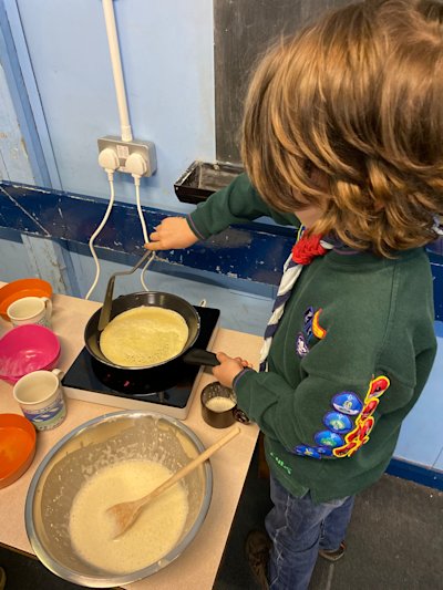 This Cub is being very careful as he prepares to flip his pancake.