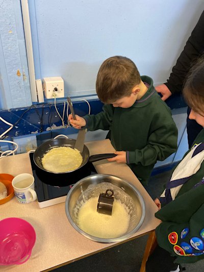 It's this Cub's first time making pancakes at Cubs. Looks like he's doing a good job!