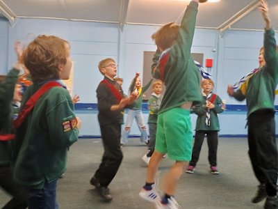 A couple of these Cubs are jumping high in an effort to intercept the ball being thrown by the other team, while the others cheer them on in excitement.