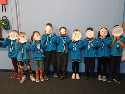 What a scary looking lot of Beavers these are, holding up their animal masks to their faces.