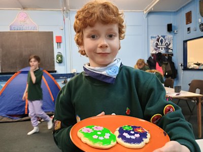 This Cub is showing off his sugar skull biscuits. They look happy!