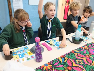 The first round of La Loteria has been won, as one line has been filled. The Cub throws her hand up in the air and shouts "La Loteria!".