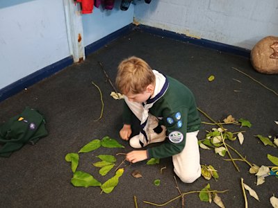 This Cub has chosen to create his fleur-de-lis from leaves and sticks.