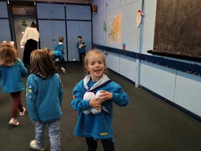 This cheeky Beaver has gathered an armful of snowballs to chuck at her leader. Uh oh!