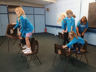 The Beavers are playing a very competitive round of the chair race. One team seems to be struggling, but the other two teams are neck and neck. Who will win? Spoiler: it was the middle team.