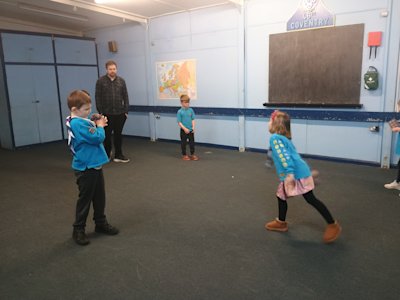 The Beavers are working on their teamwork and coordination skills by tossing beanbags between each other.