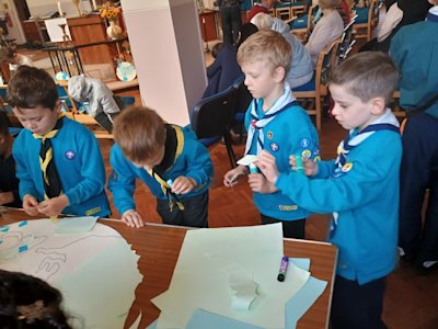 Four Beavers are tearing pieces of paper and sticking them onto the planet half. They seem to be rather more careful than the young people working on the other planet half!