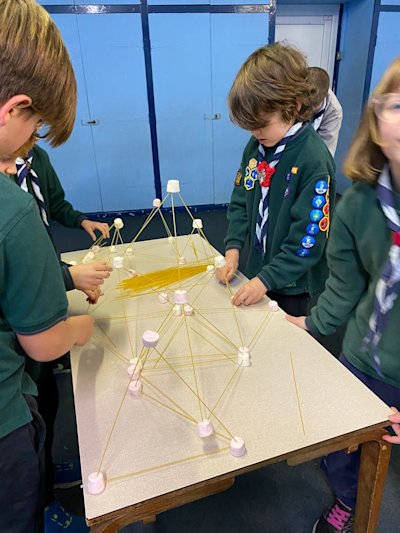 The Howlers Six are working hard on building their tower using marshmallows and spaghetti.