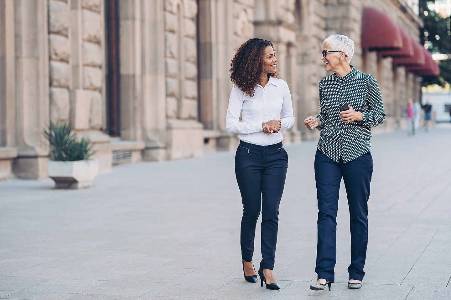Two women walking and talking